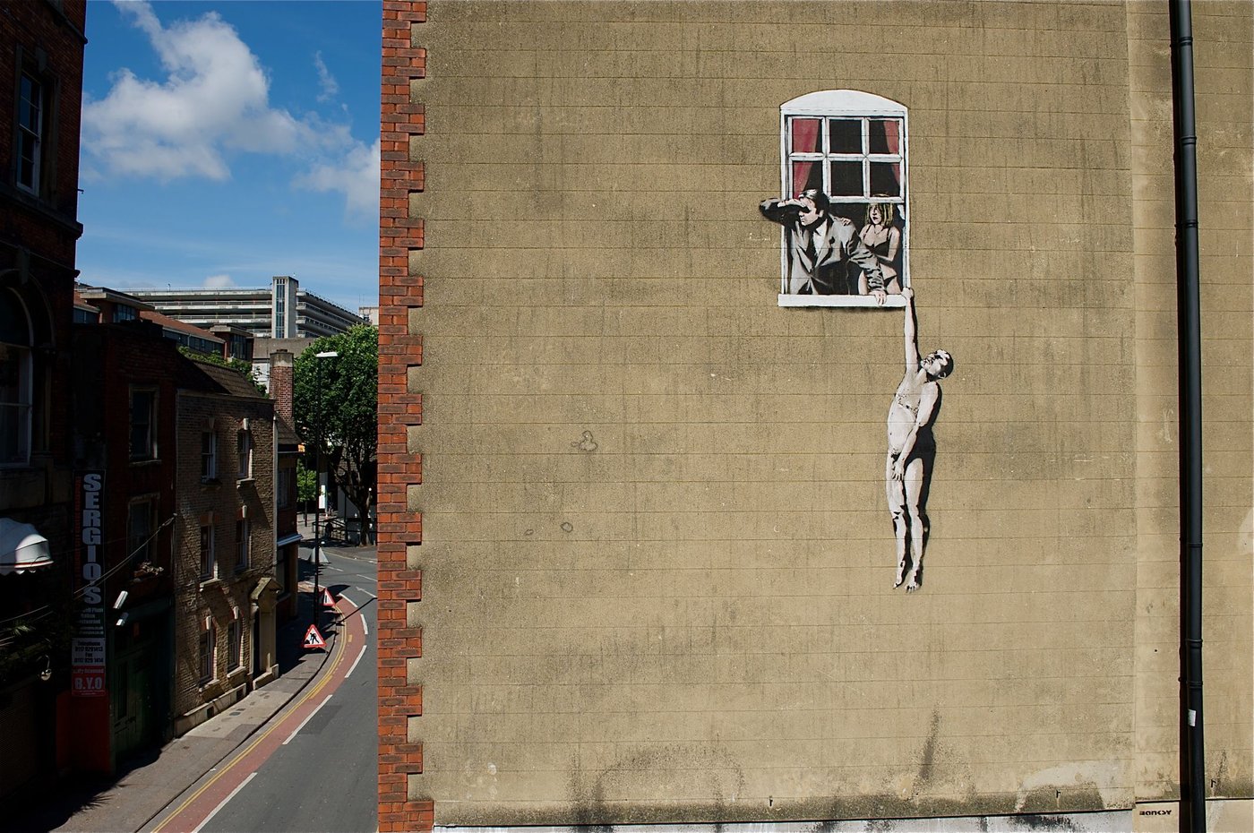 Banksy, Naked Man Hanging From Window mural