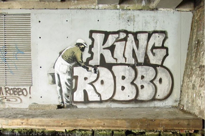 2009 – Banksy paints a bloke ‘wallpapering' up the graffiti