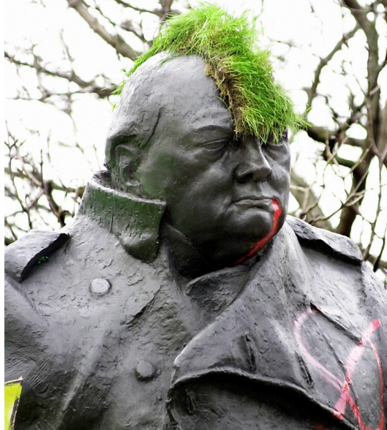 The Churchill statue turfed during the May Day riots — the gesture the print records.